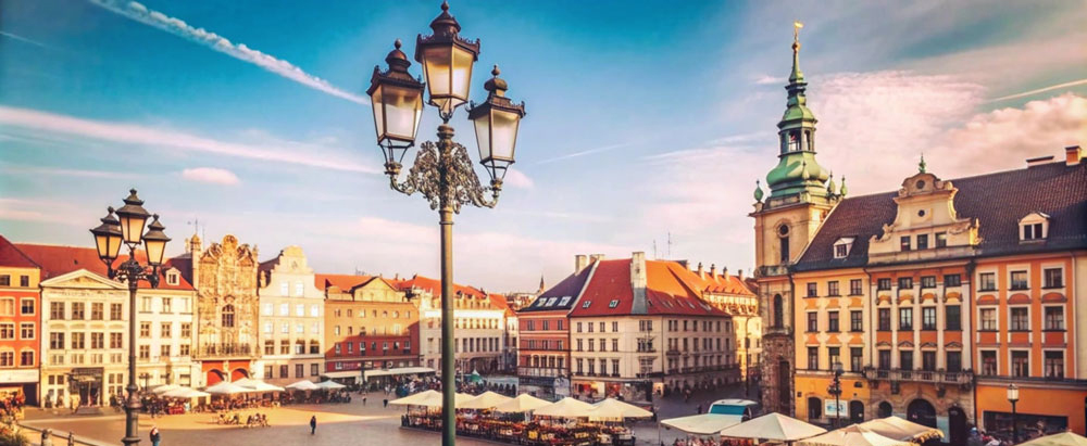 Sunny day in a European city square with historic buildings, str